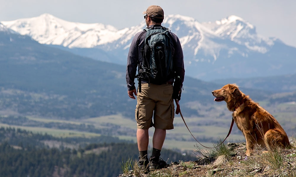 Photo of a man hiking with this dog