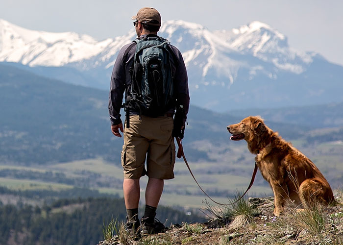 Man on Dog on Mountain Hike